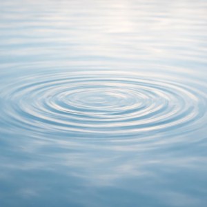 Concentric ripples on calm blue water